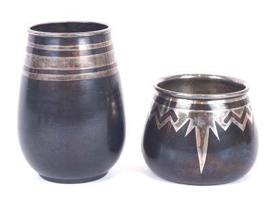 two vases sitting next to each other on a white surface