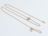 a gold chain with a small diamond on it