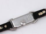 a close up of a watch on a white surface