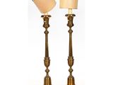 a pair of brass candlesticks with a beige shade