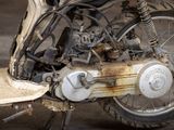 a close up of an old motorcycle with a rusted tire