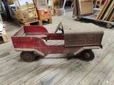 a red toy truck that is sitting on the floor