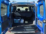 a blue van that is parked in the parking lot
