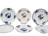 six blue and white plates with blue flowers on them on a white surface