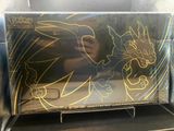someone is drawing on the back of a box of pokemon trading cards
