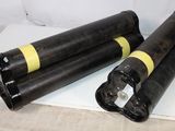 two black and yellow cylinders sitting on a white surface