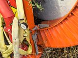 a large orange brush sitting on top of a pile of hay