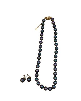 a close up of a necklace and earrings on a white background