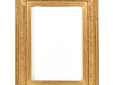 a gold frame on a white wall with a white background
