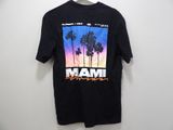 a black t - shirt with a picture of palm trees on it