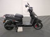 a scooter that is parked on a checkered floor