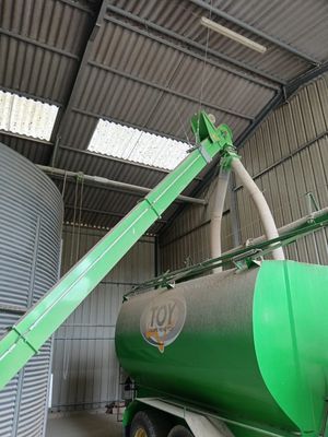 a truck with a large green tank on the back of it
