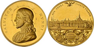a close up of a gold coin with a picture of a man on it