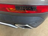 the rear end of a car with a sticker on it ' s bumper
