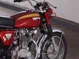 a red motorcycle that is parked in a garage