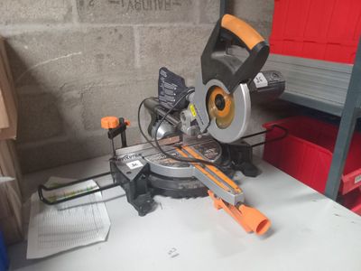 a mitre saw sitting on a table in a garage