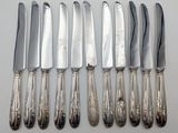 five knives and six knives on a white table
