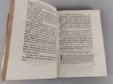 an open book on a table with writing on it