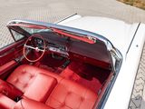 a white car with red leather seats and a steering wheel