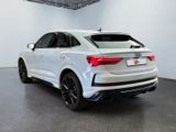 the rear end of a white audi qx parked in a showroom