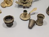 many different types of brass objects on the table
