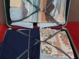 a open suitcase with a bunch of folded clothes inside of it