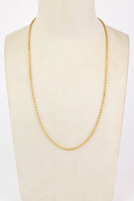 a gold chain necklace on a mannequin mannequin