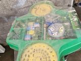 a green tray with food on it sitting on the floor
