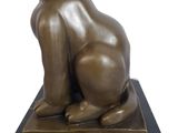 statue of a cat sitting on a black marble base