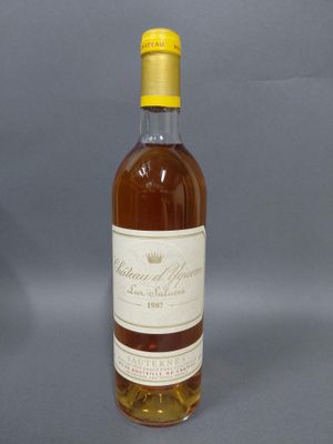 une bouteille de vin posée sur une table devant un fond gris