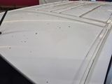 a close up of a white car with a broken hood