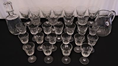 a lot of wine glasses and a decanter on a table