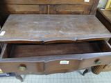a wooden dresser with two drawers in the middle of it
