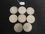 six different types of coins on a table with a price tag