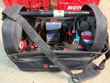 un sac contenant des outils, posé par terre