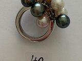 a picture of a ring with different colored pearls on it