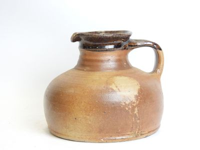 a brown vase with a brown handle on a white surface