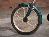 a close up of a green motorcycle with a black tire