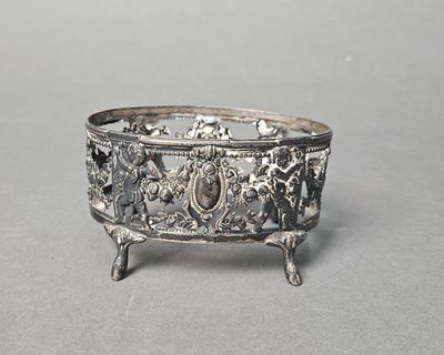 a silver bowl with a design on it sitting on a table
