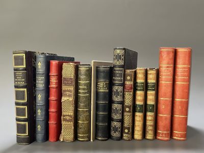 several old books are lined up in a row on a table