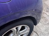 a purple car parked on the side of the road