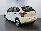 the rear end of a white citrole parked in a showroom