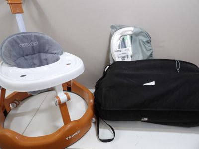 a baby walker and a bag sitting on a table