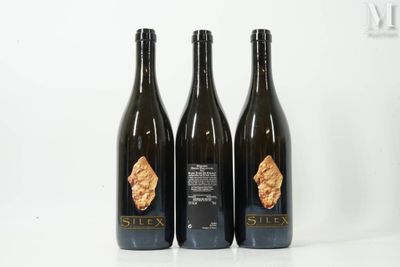 trois bouteilles de vin posées l'une à côté de l'autre sur une table