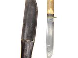 a knife that is laying next to a knife sheath
