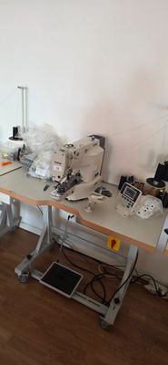 two sewing machines sitting on a table in a room
