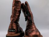 a close up of a pair of metallic boots on a white background