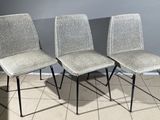 three chairs are sitting on a tiled floor in a room