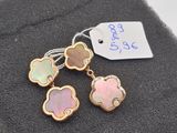 a close up of a pair of earrings with a tag on it