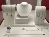 a display of jewelry on display in a glass case